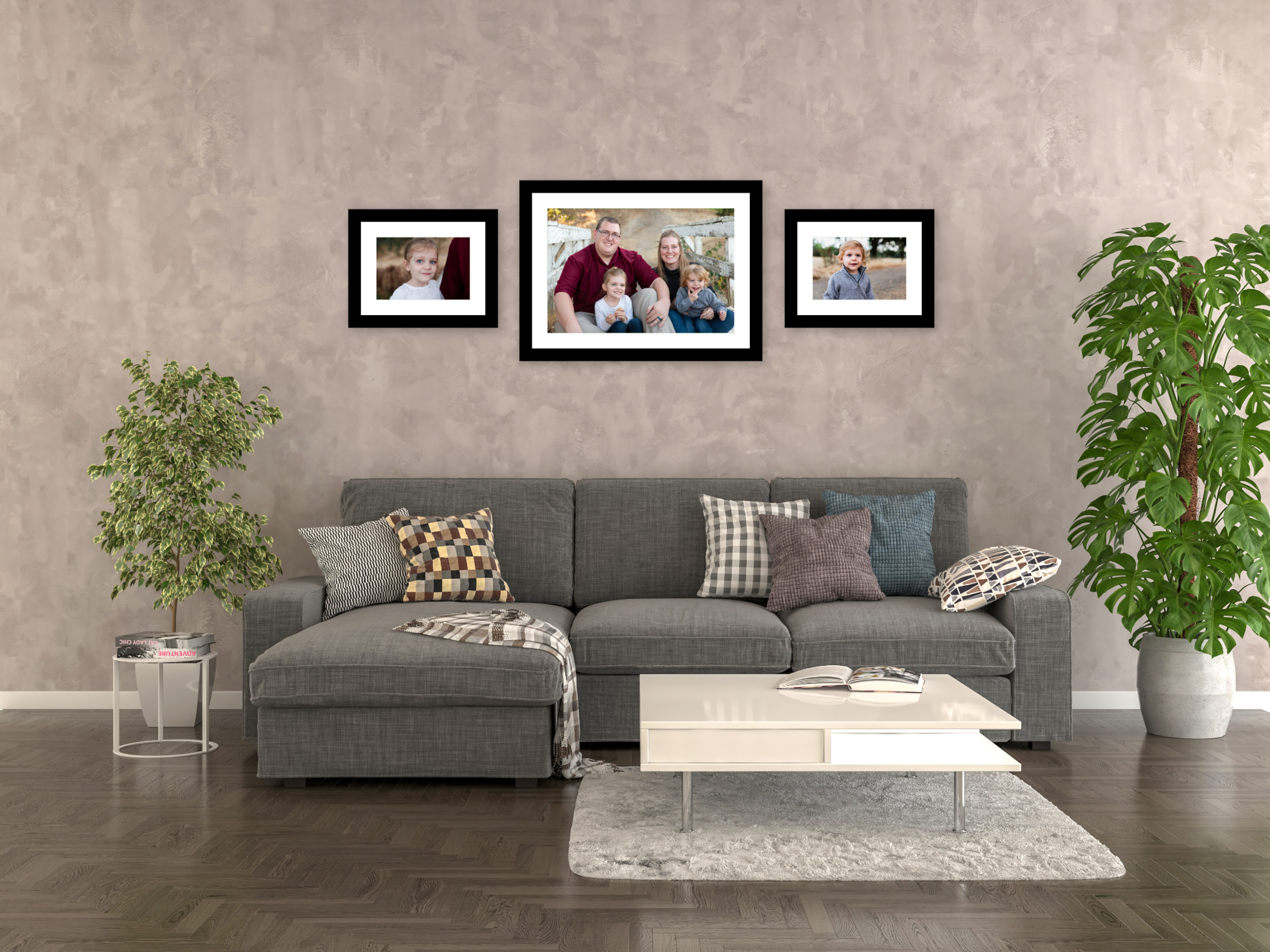 Wall gallery of family portraits over sofa; images by Robin Collette Photography